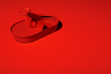 Dark red tin can on red background
