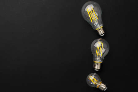 Compact light bulb isolated on black backgroundの写真素材