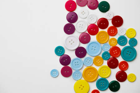 Assortment of colorful buttons on white backgroundの写真素材
