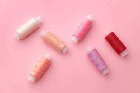 Set of threads spools on pink backgroundの写真素材