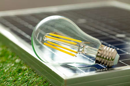 Solar energy panel and light bulb, green energyの写真素材