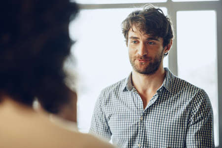 Close up photo of two male colleagues discussing project in office