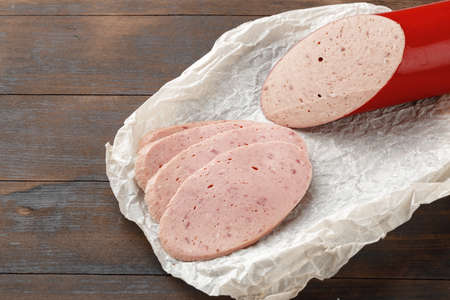 Cut chicken sausage slices on wooden table