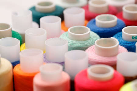 Close up of colored thread coils, thread spools background