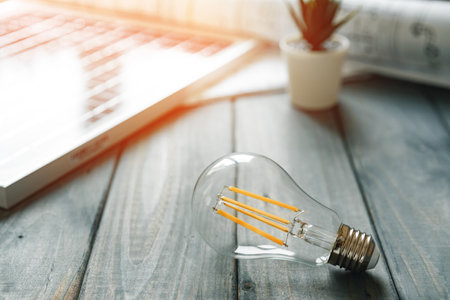 Light bulb on gray wooden table close upの写真素材