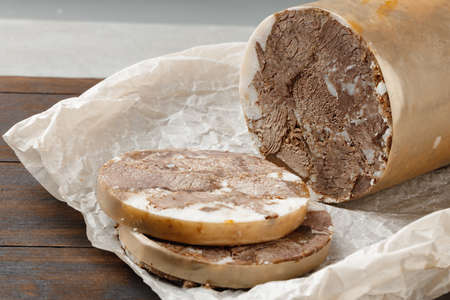 Chopped meat sausage on wooden board close upの写真素材