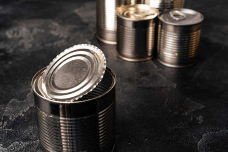 Tin cans with conserved food on gray surfaceの写真素材