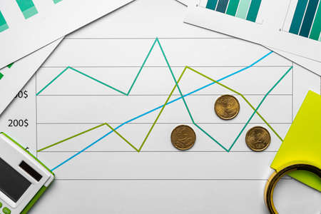 Financial paper with charts and diagrams on gray tableの写真素材