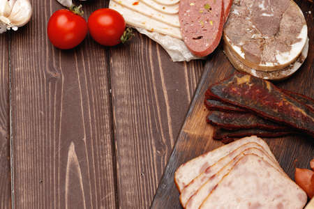 Assortment of meat and sausage on wooden surfaceの写真素材