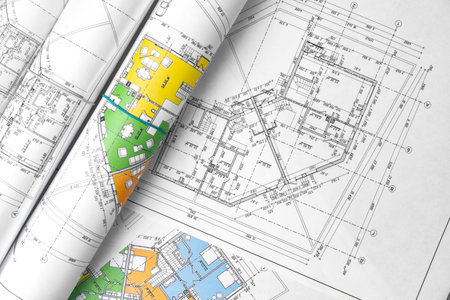 Architectural construction plans paper on table close up