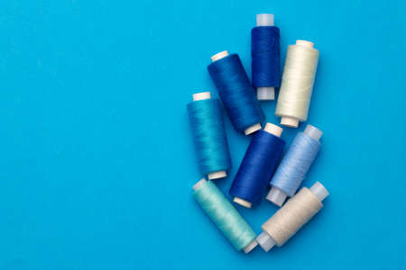 Many colored spools of threads as a backgroundの写真素材