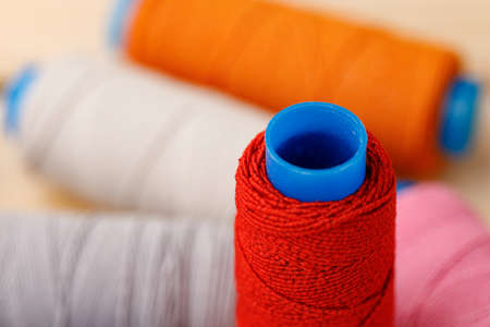 Close up of colored thread coils, thread spools backgroundの写真素材