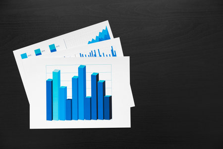 Financial paper with charts and diagrams on gray table
