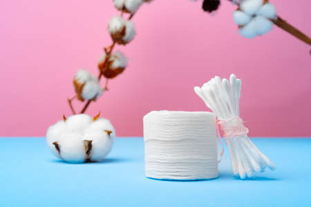 Cotton buds for cleaning ears on pink and blue backgroundの写真素材