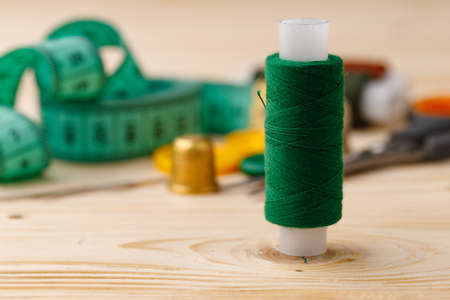 Threads and sewing accessories on wooden tableの写真素材