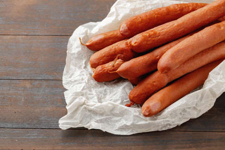 Fresh meat sausages on brown wooden table