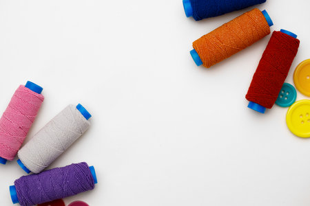 Colored spools of threads on white backgroundの写真素材