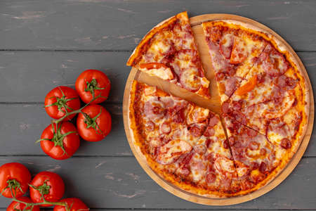 Delicious pizza on gray wooden background top viewの写真素材