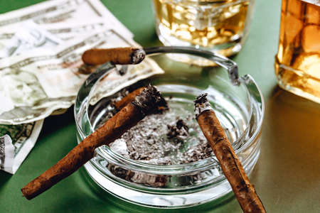 Cuban cigar and money on green backgroundの写真素材