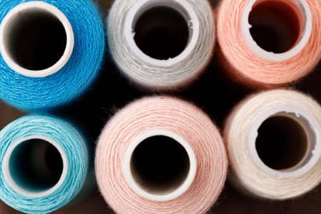Close up of colored thread coils, thread spools backgroundの写真素材