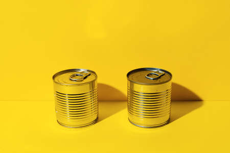 Canned food tin on yellow studio backgroundの写真素材