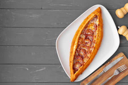 Turkish stuffed flatbread pide on gray wooden tableの写真素材