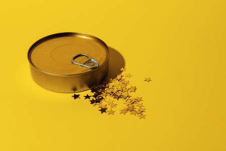 Canned food tin on yellow studio background