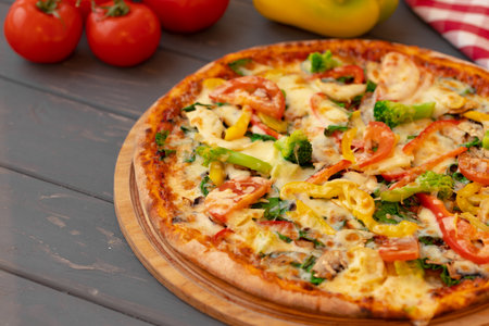 Close up of freshly baked pizza on black wooden tableの写真素材
