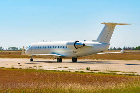 Big passenger airplane drives along the runway in airportの写真素材