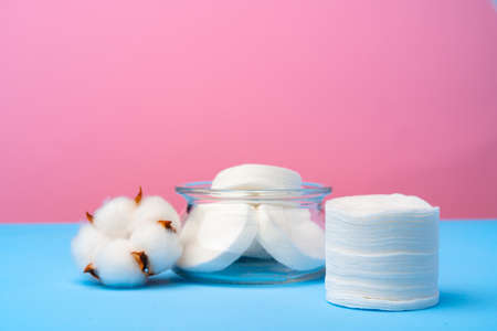 Cotton flower and cotton discs on paper backgroundの写真素材