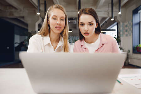 Two women entrepreneurs working together in officeの写真素材