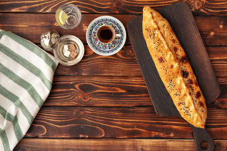 Pide - Turkish baked bread on wooden tableの写真素材