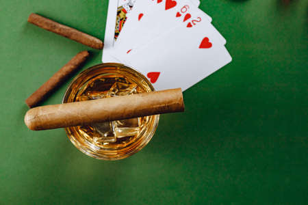 Cigar and playing cards on casino tableの写真素材