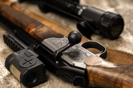 The optical sight and shotgun on wooden backgorundの写真素材