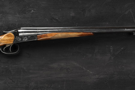 Smoothbore hunting gun on black background close up