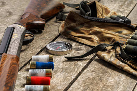 Various hunting equipment on old wooden background
