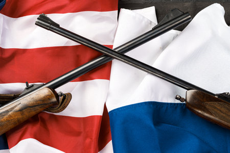 Usa flag and Russia flag background with two crossed shotgunsの写真素材