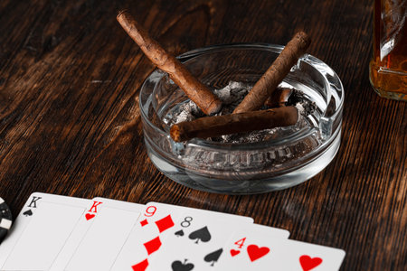 Cigar and playing cards on casino table
