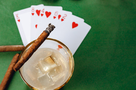 Cigar and playing cards on casino table
