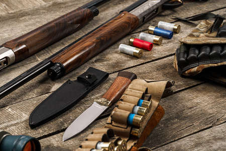 Various hunting equipment on old wooden background
