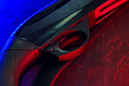 Hunting shotgun on black background with red and blue backlightの写真素材