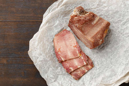 Sliced baked pork meat on wooden backgroundの写真素材