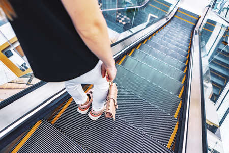 Young woman standing at the escalator in subwayの写真素材