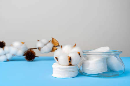 Cotton discs stack on blue paper backgroundの写真素材