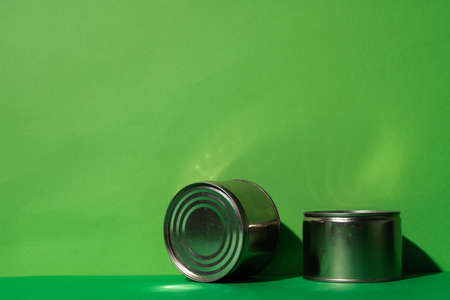 Canned food tin on green studio background