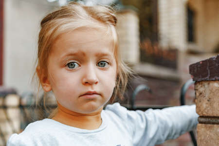 Close up portrait of a little blonde girl on a summer dayの写真素材