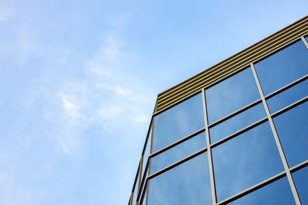 Glass skyscraper against blue sky, view from bottomの写真素材