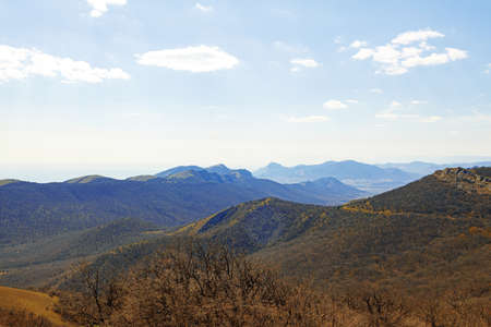 Mountains landscape against blue sky with clouds on sunny dayの写真素材