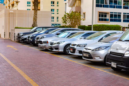 DUBAI, UAE - MARCH 2020: Cars on the parking in a street of Dubaiのeditorial素材