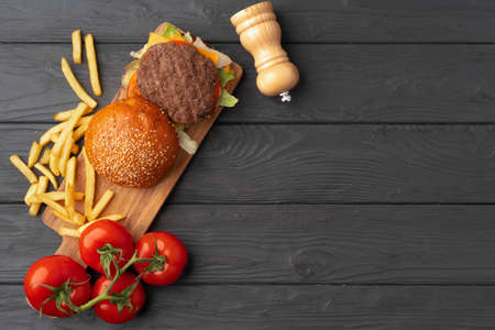 Fresh burger and fries on black wooden backgroundの写真素材